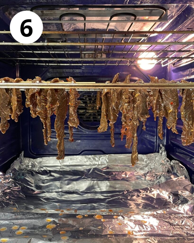 hanging beef jerky on wire racks in oven