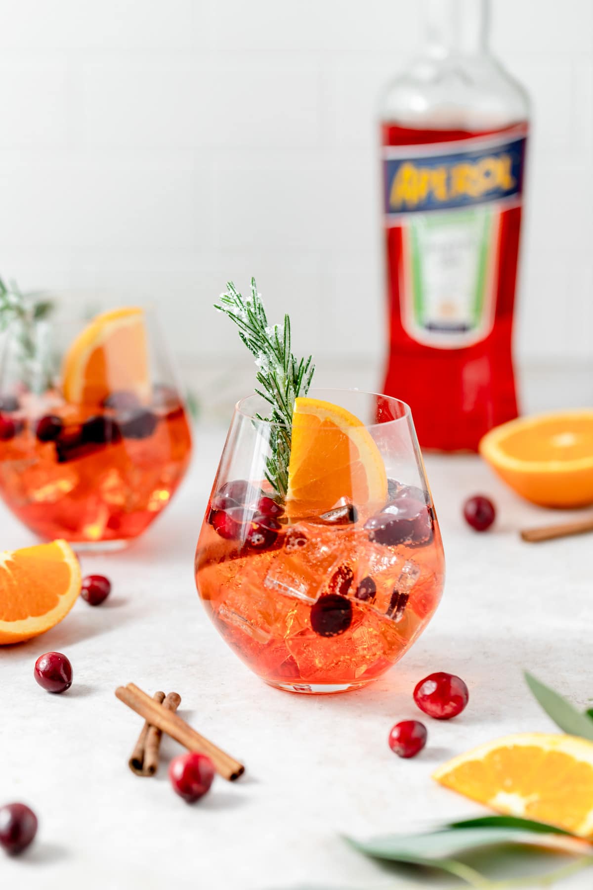aperol spritz with cranberries and rosemary 