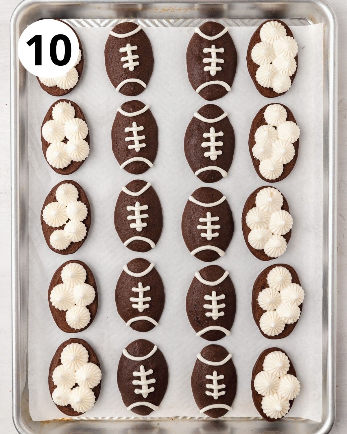 piping marshmallow buttercream into chocolate football whoopie pies