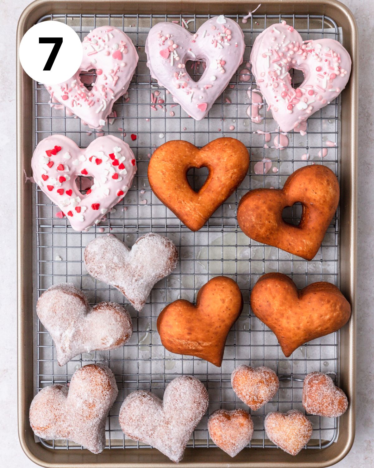 fried heart shaped donuts before glazing and rolling in sugar.