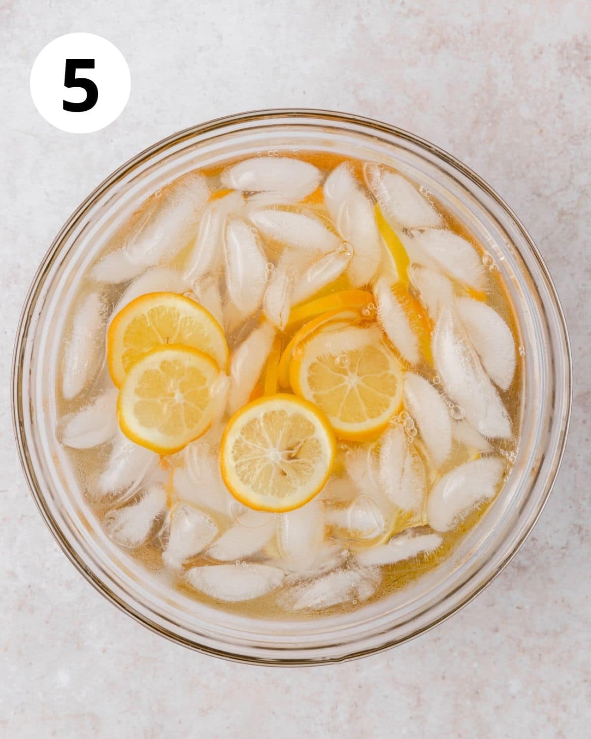 sliced lemons in an ice bath after blanching.
