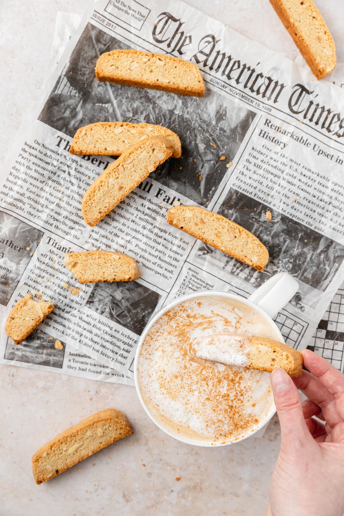 Dipping brown butter almond biscotti in latte