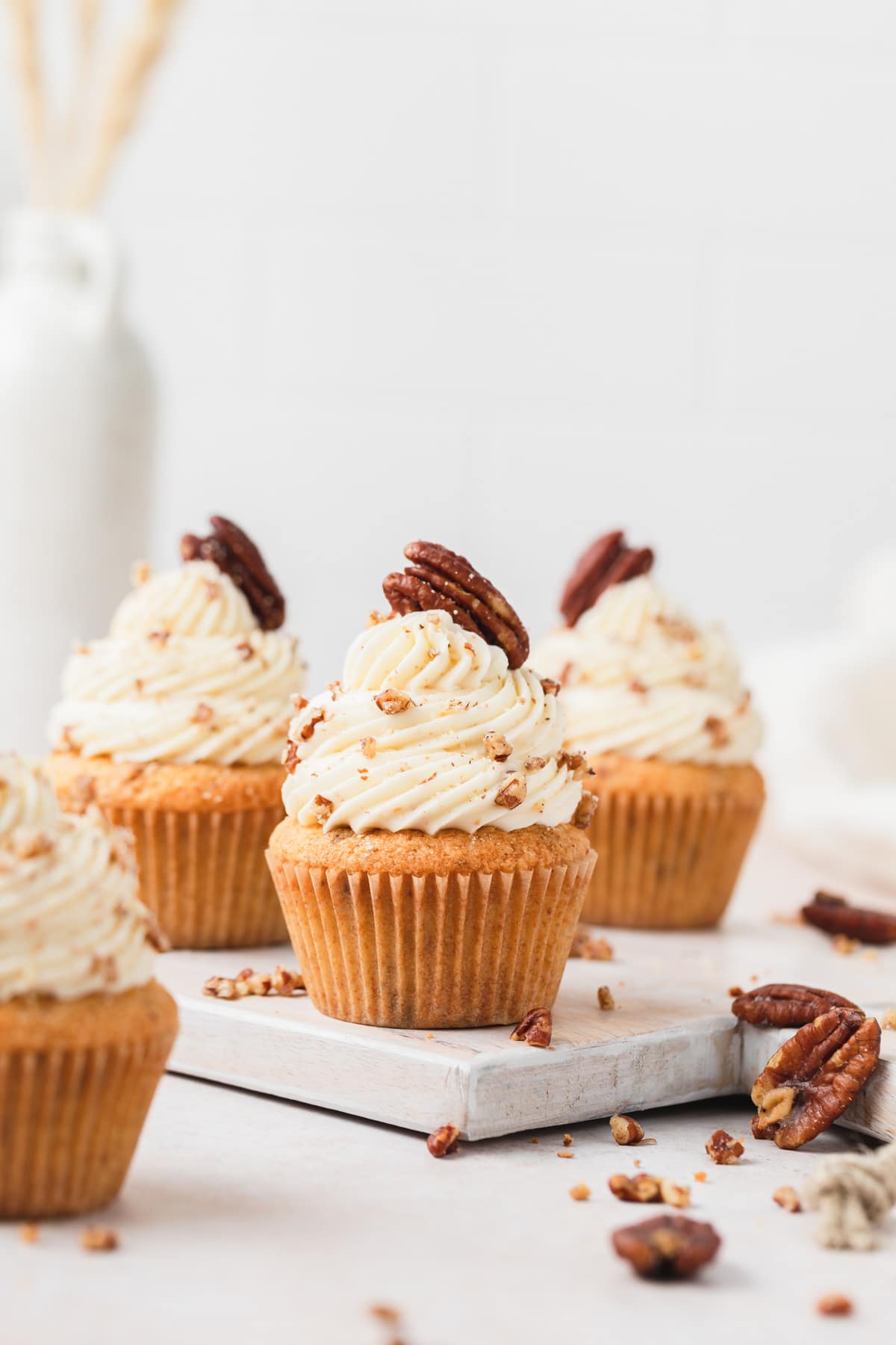 brown butter pecan cupcakes with buttered pecans on top