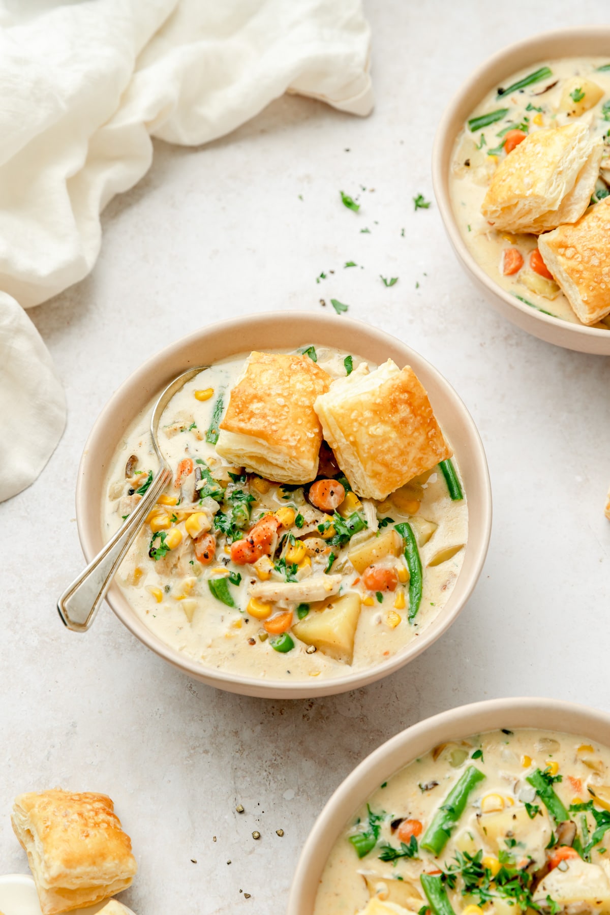 bowl of creamy chicken pot pie soup with puff pastry bites on top.