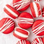 close up shot of red velvet macarons with cream cheese frosting