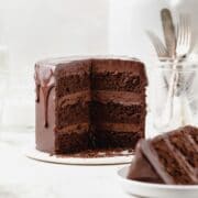 super close up shot of triple chocolate layer cake with chocolate drip.