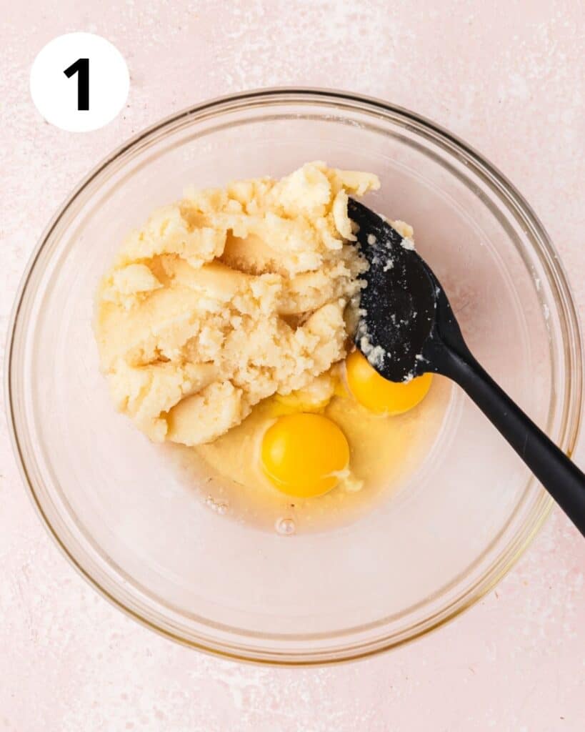 eggs, sugar, and butter in bowl with lavender extract.