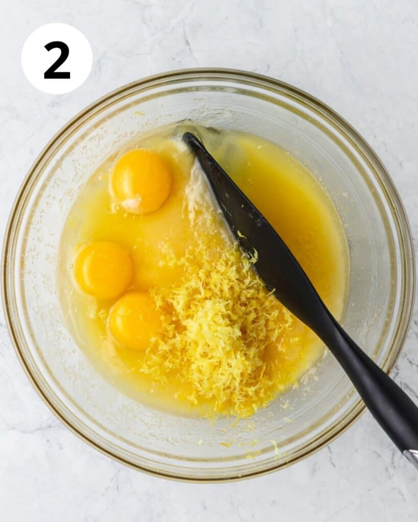adding in eggs and lemon zest.