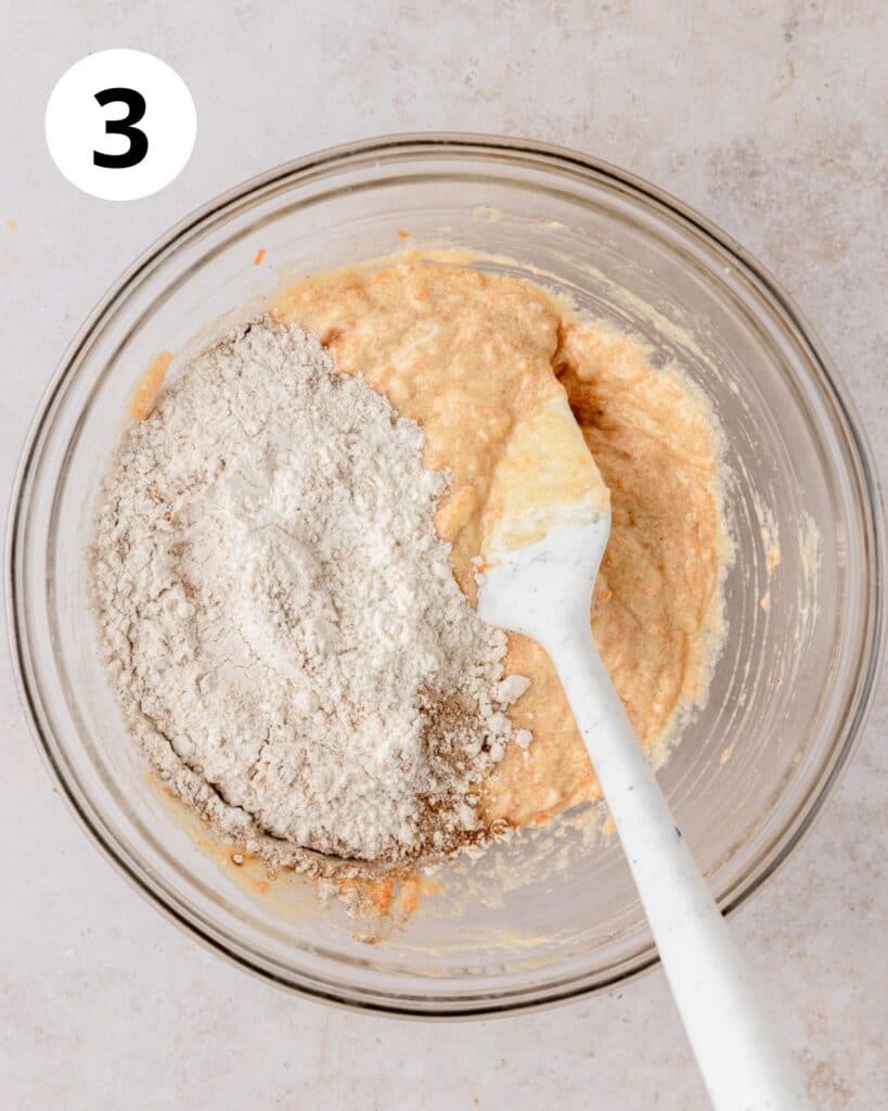 adding dry ingredients to cupcake batter.