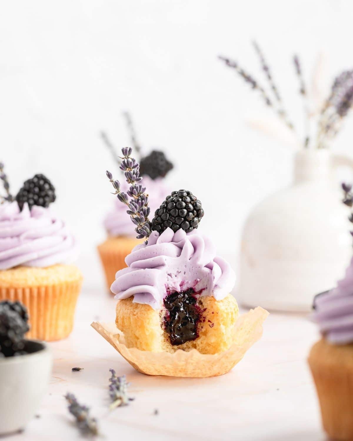 blackberry lavender cupcakes with bite cut out to see the blackberry filling.