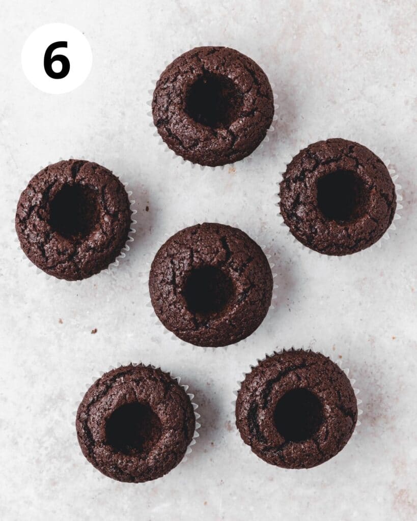 chocolate cupcakes with centers removed.