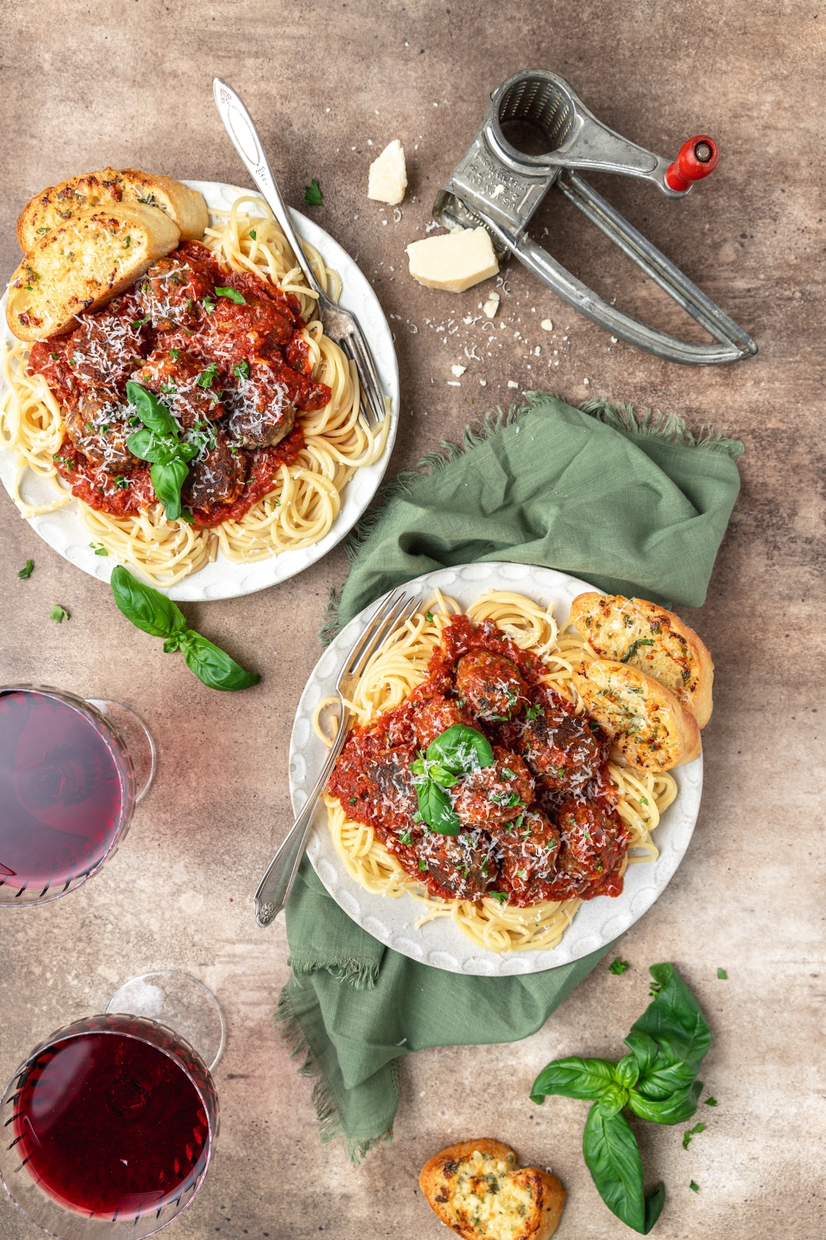 plates of spaghetti and meatballs with homemade sauce and fresh herbs.