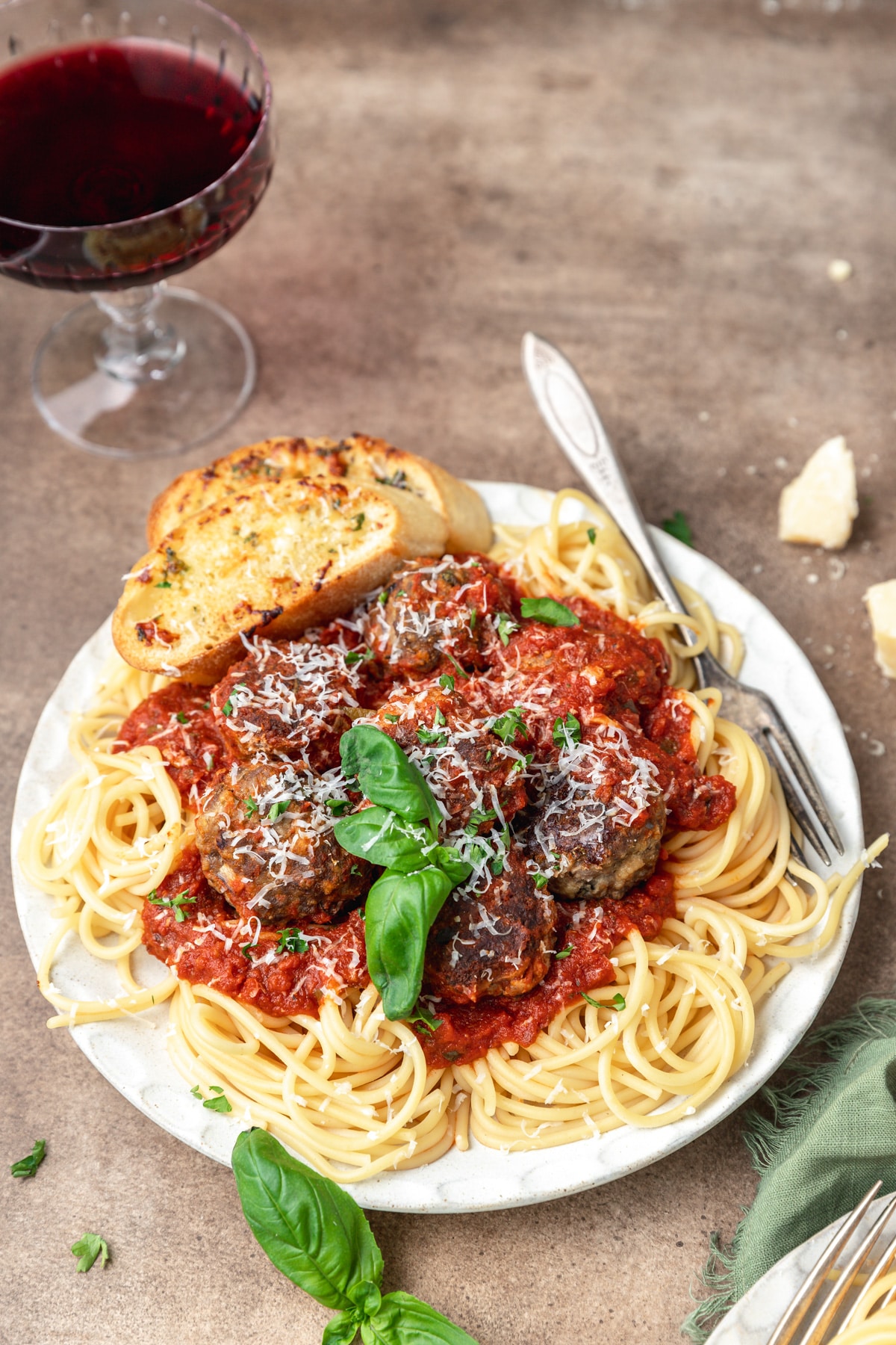 italian meatballs on pile of spaghetti with homemade sauce.