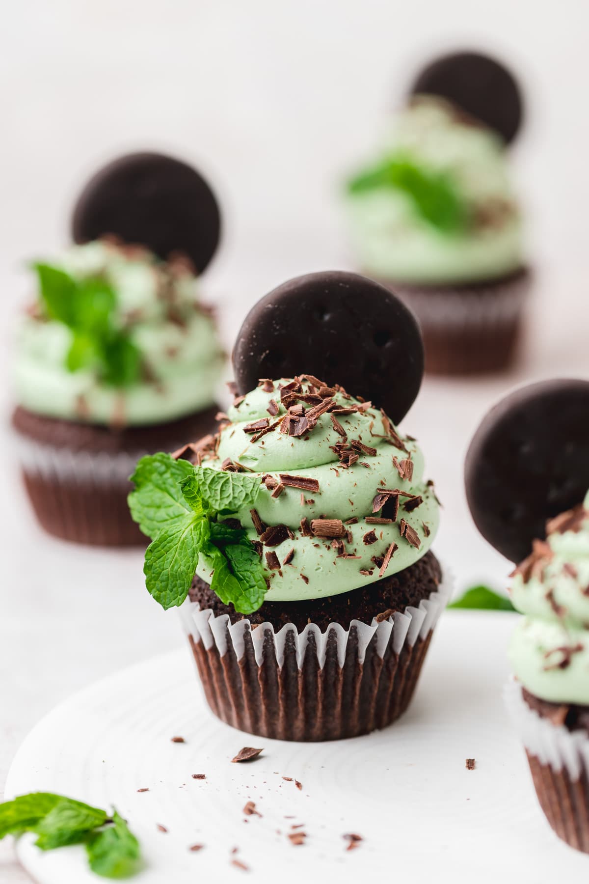 mint chocolate cupcakes with fresh mint and thin mint cookie.
