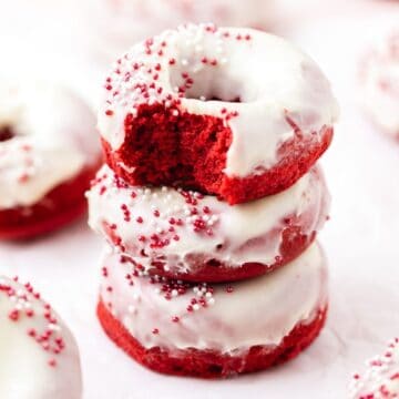 close up shot of red velvet baked donuts with cream cheese frosting.