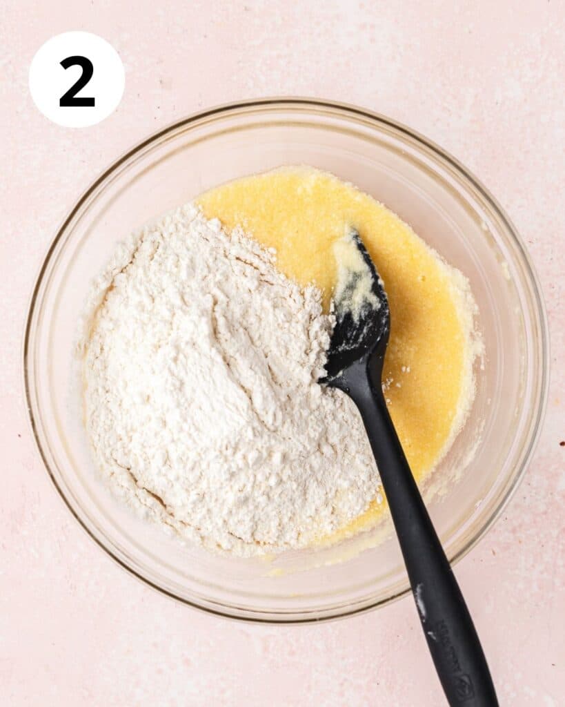adding dry ingredients to lemon cupcake batter.