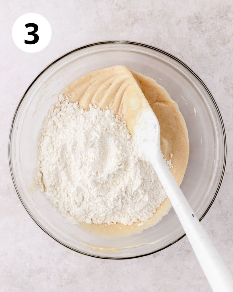 adding dry ingredients to brown butter cupcake batter.