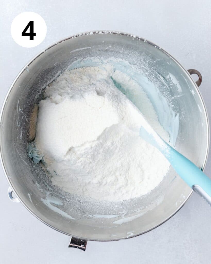 adding dry ingredients to macaron batter.