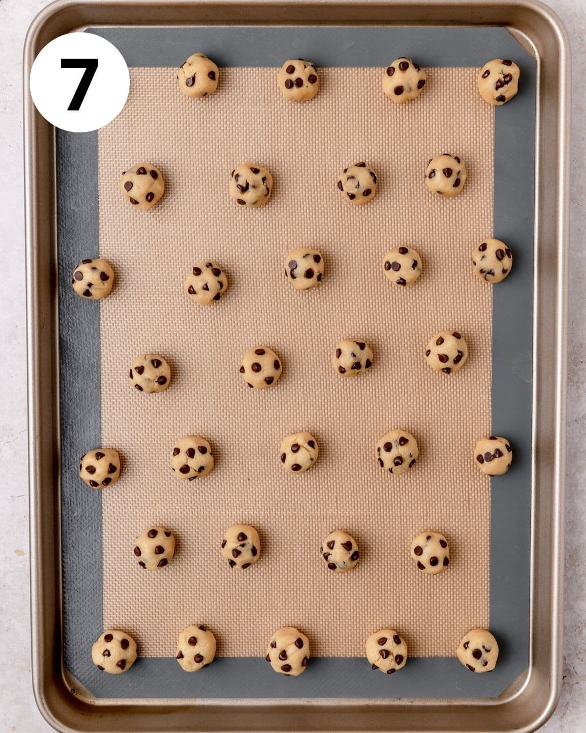 mini cookie dough balls on baking sheet.