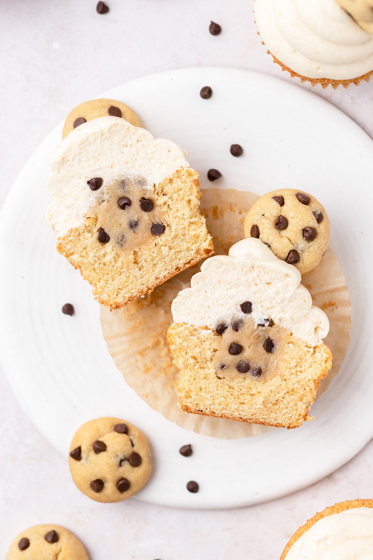 chocolate chip cookie dough cupcakes cut in half with cookie dough inside.