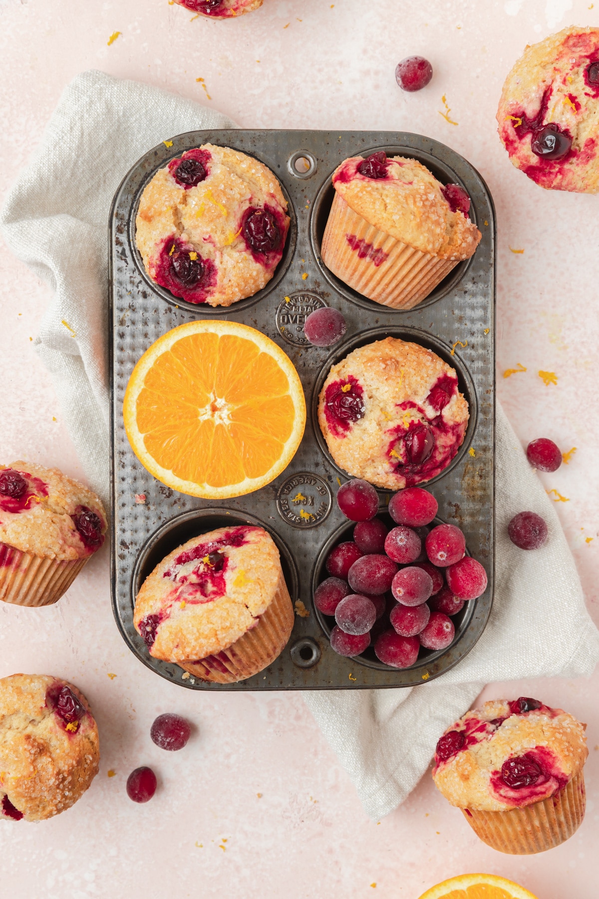 cranberry orange muffins in muffin tin.