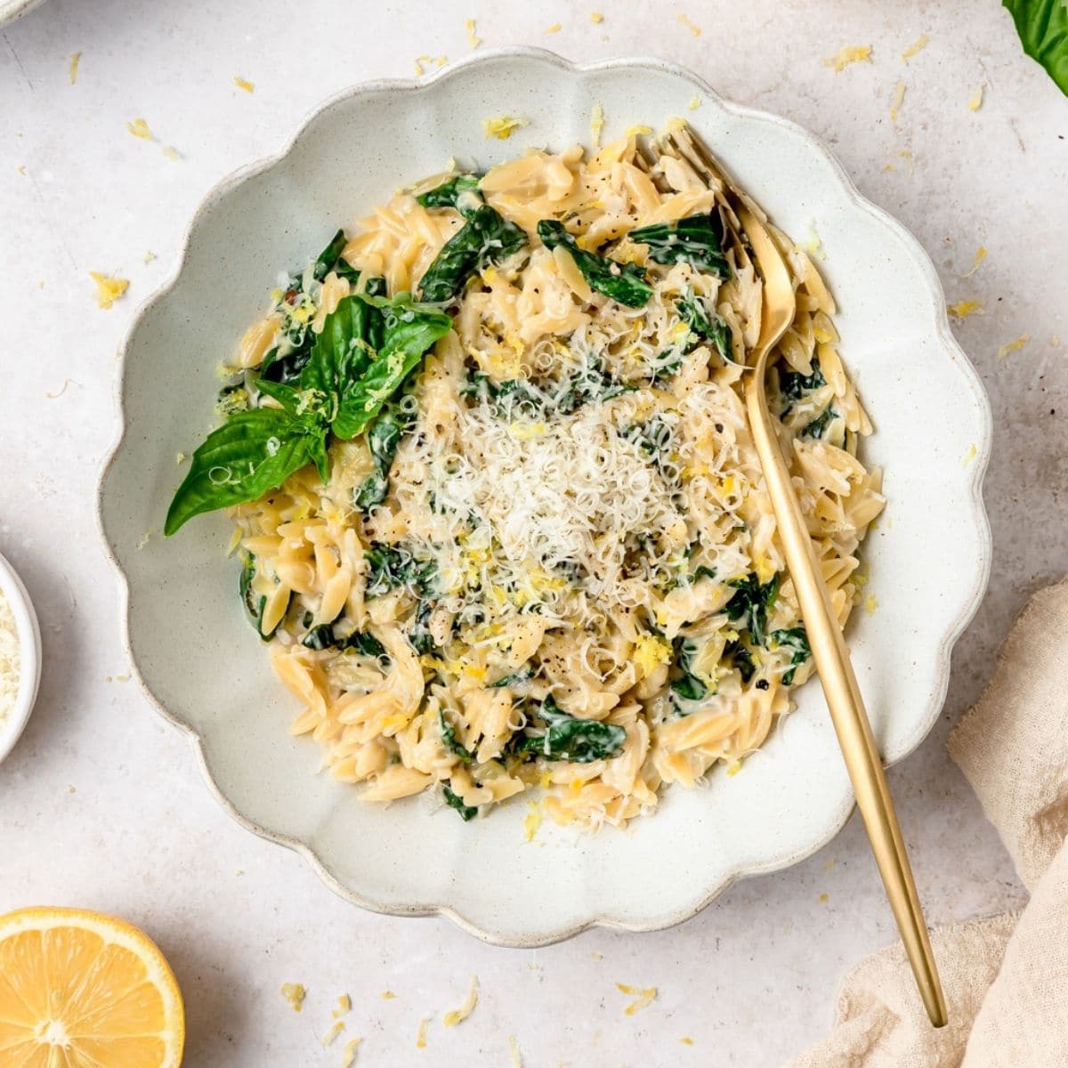 close up shot of creamy lemon spinach orzo.