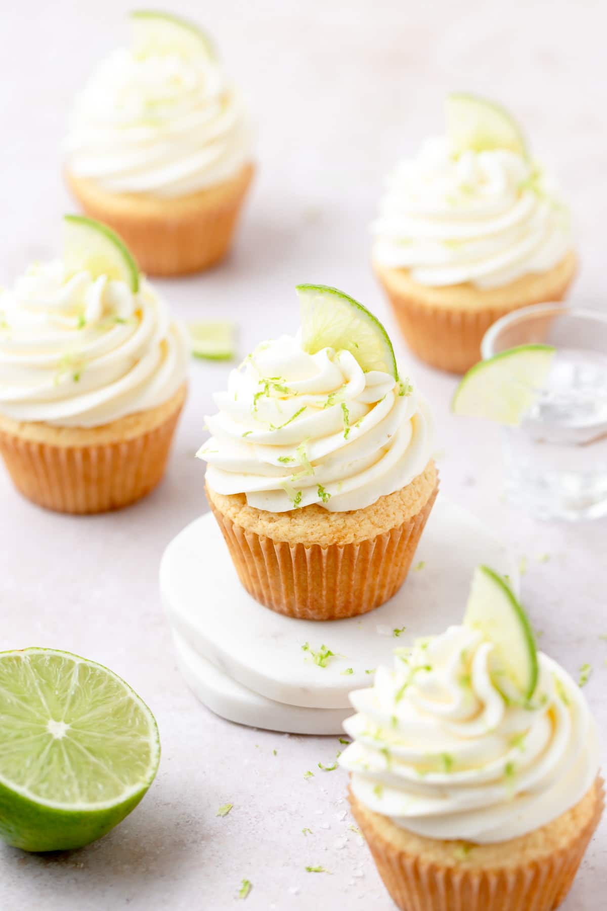 boozy margarita cupcakes with tequila lime frosting and lime slices.