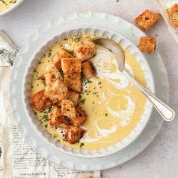 close up shot of creamy potato leek soup with homemade croutons