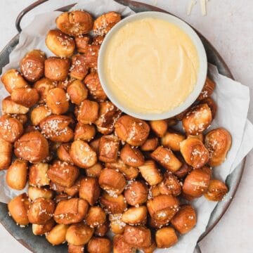 close up shot of pretzel bites with mustard cheese dip.