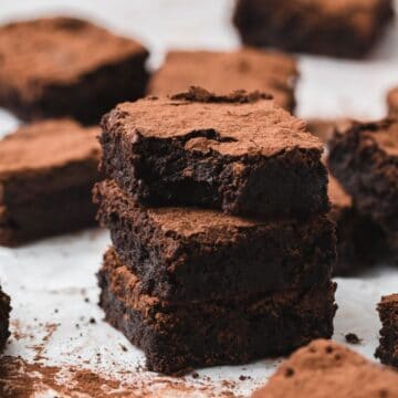 close up shot of red wine brownies with cocoa powder on top.