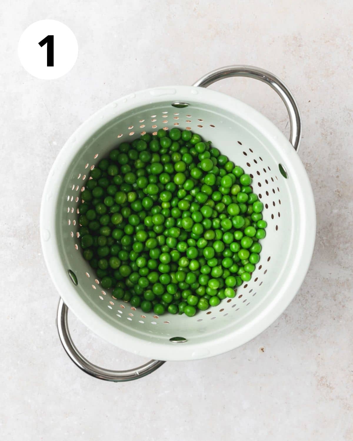 blanched peas in strainer.