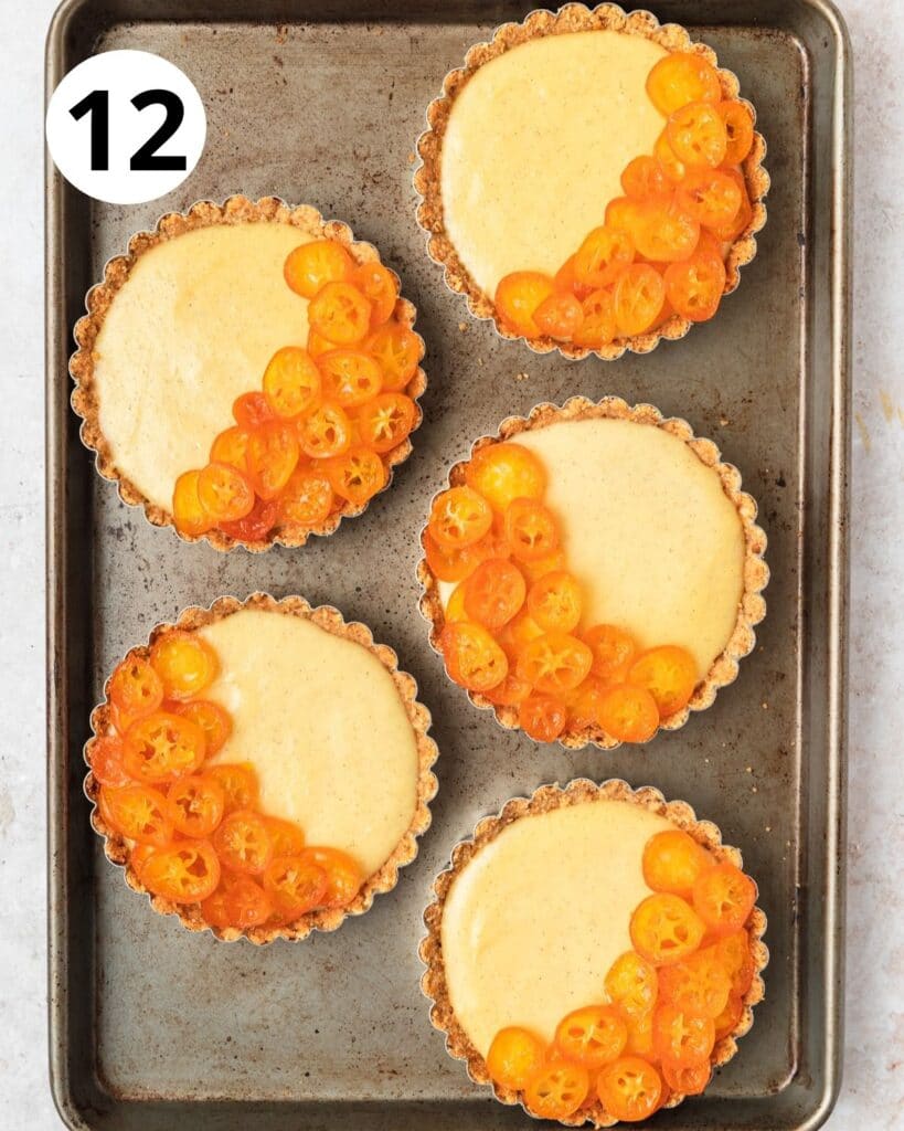 topping custard tarts with candied kumquats.