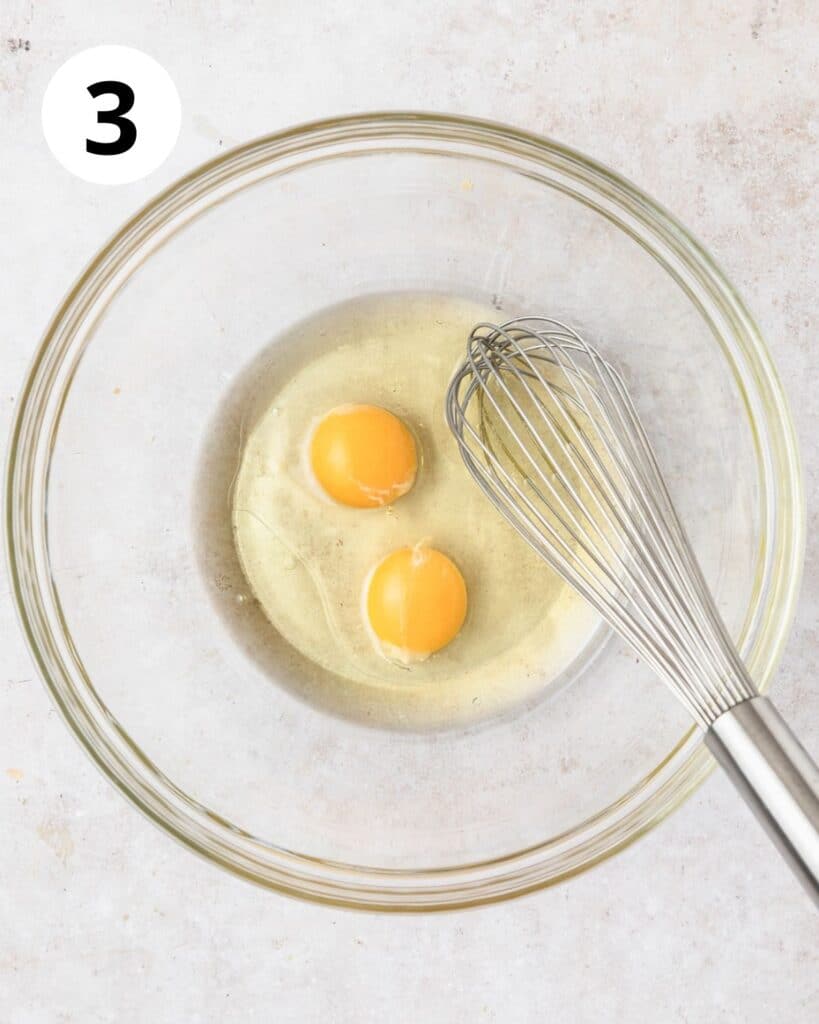 whisking oil and eggs in bowl.