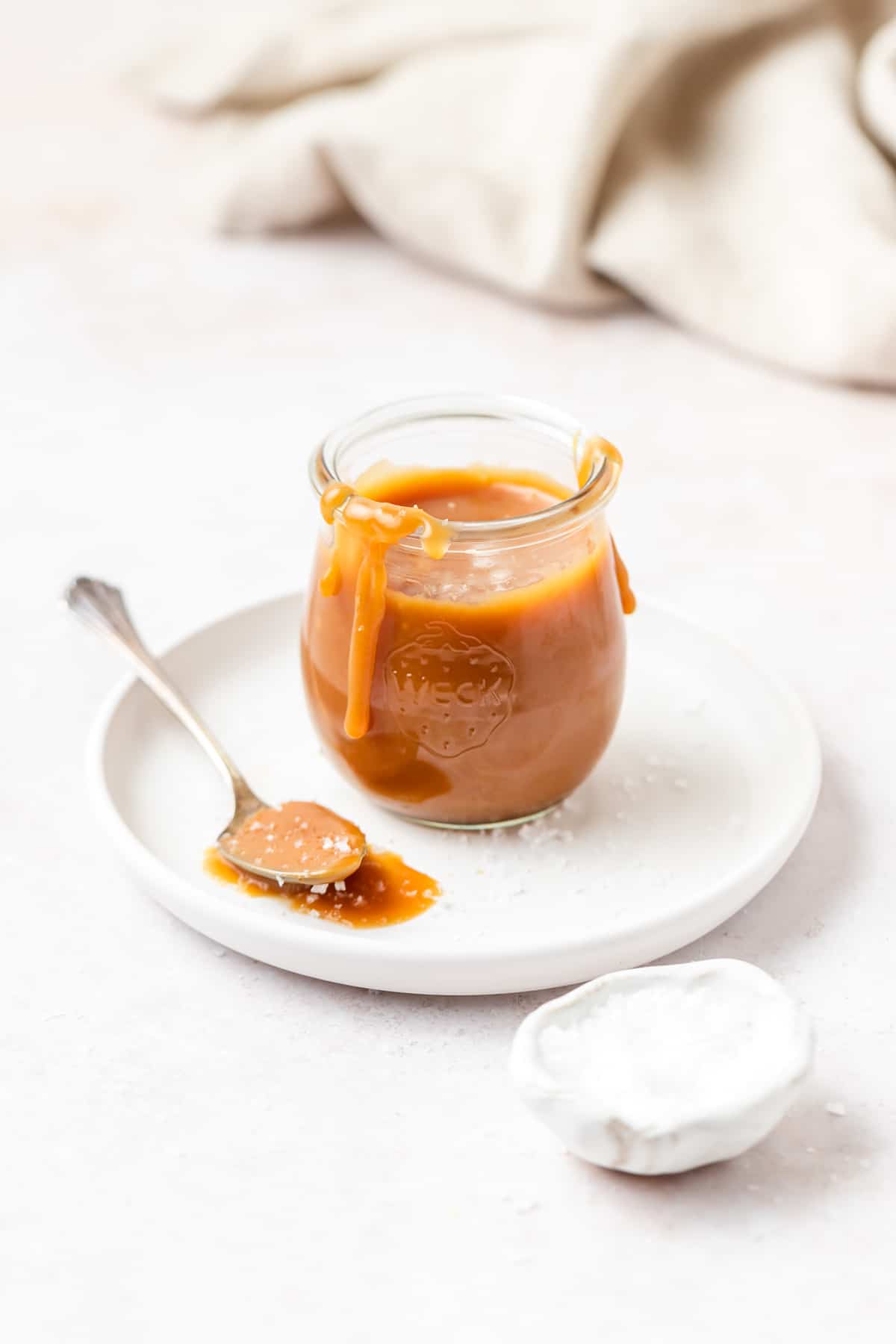 homemade salted caramel in small glass jar.