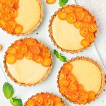 close up shot of candied kumquat custard tarts.