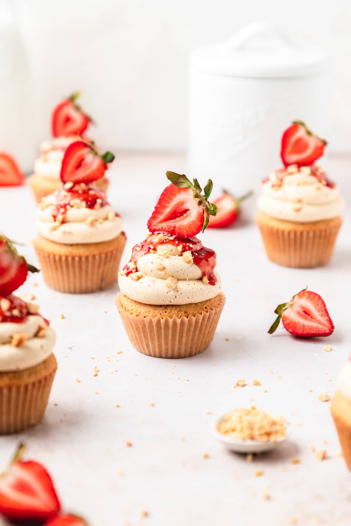 peanut butter and jelly cupcakes with strawberries on top.