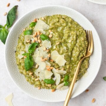 close up shot of pesto risotto with toasted pine nuts.