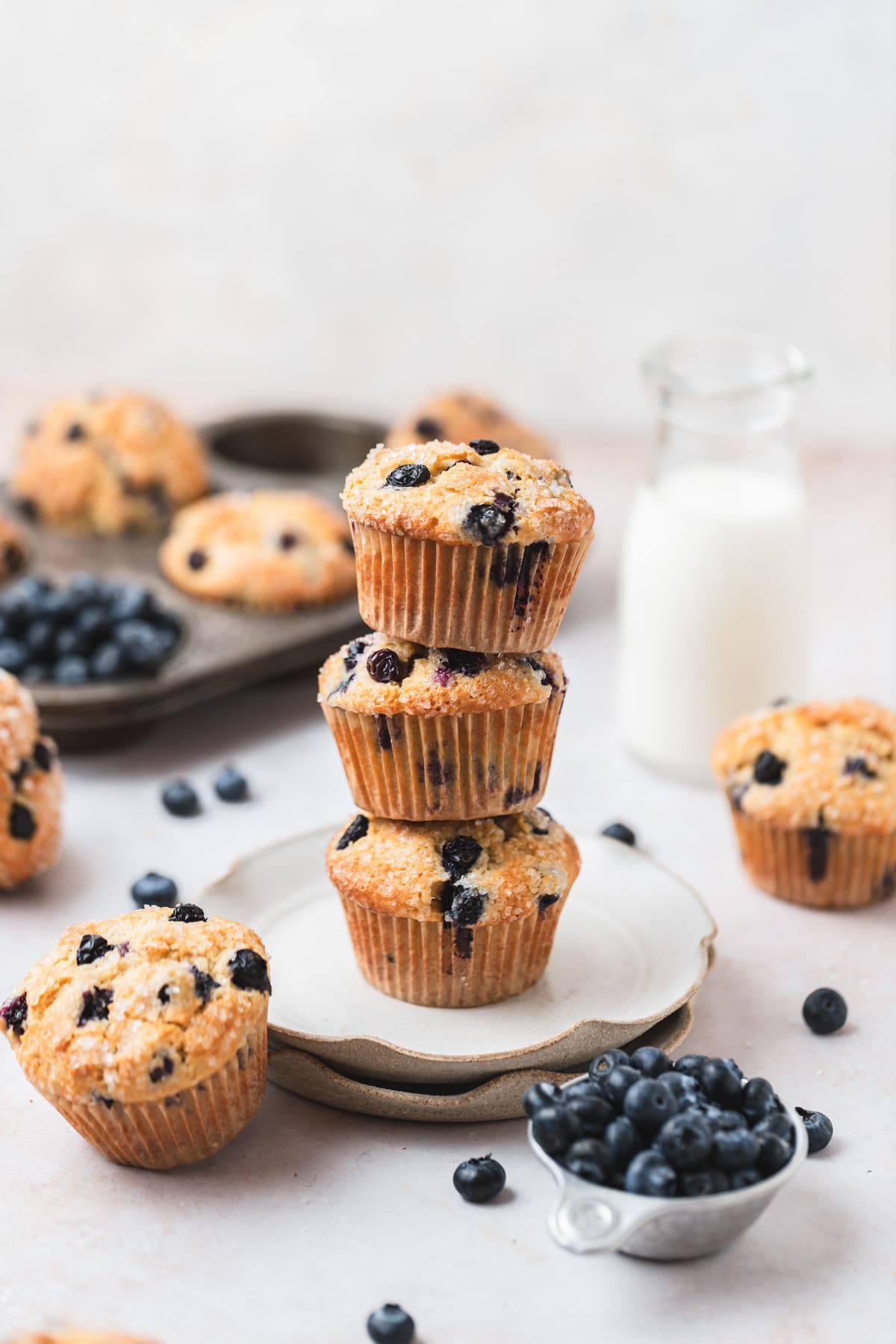 stack of sourdough blueberry muffins on plate.