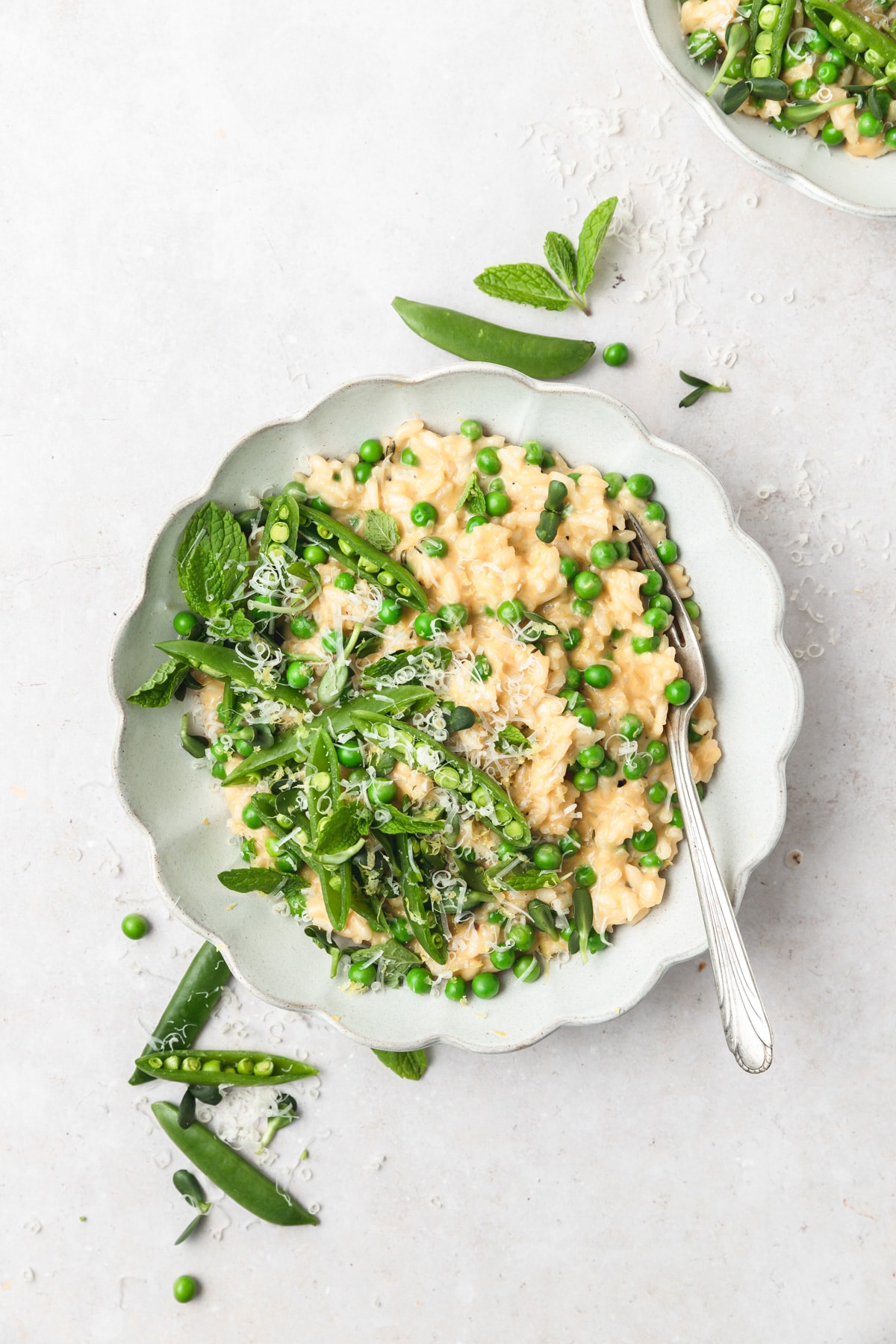 risotto topped with parmesan and spring peas.