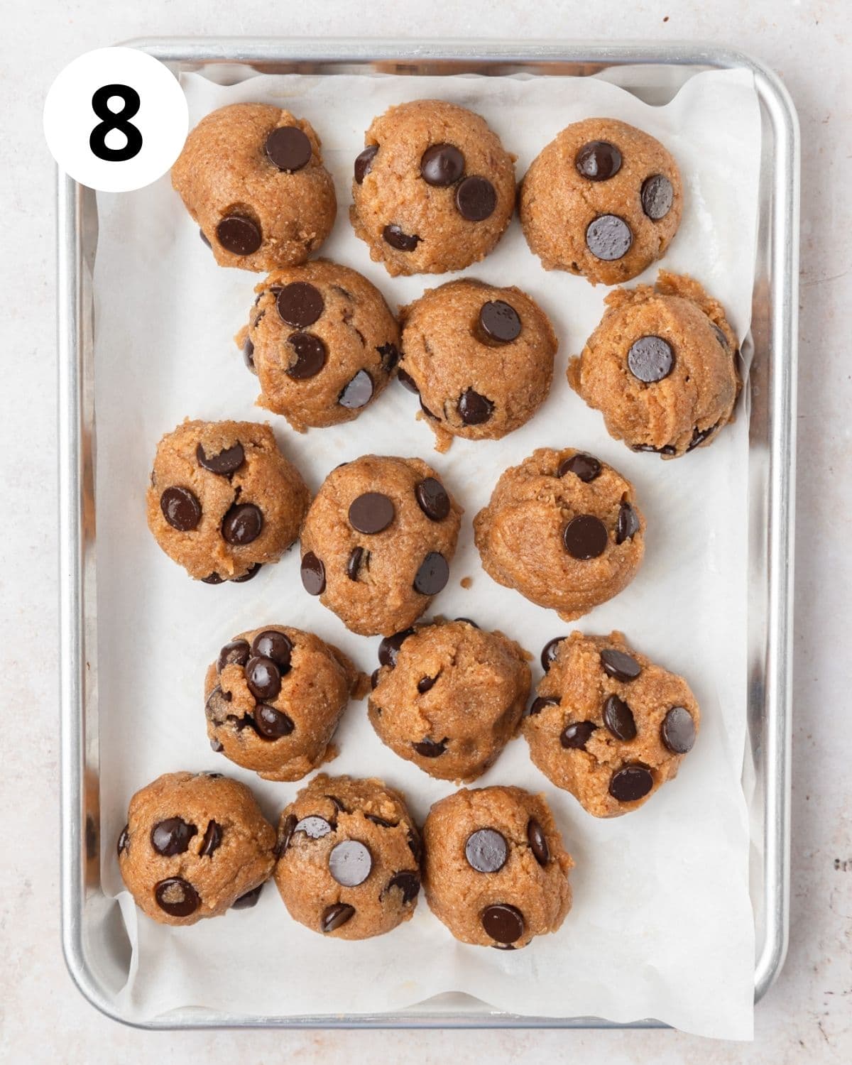 chocolate almond butter cookie dough balls on baking sheet.