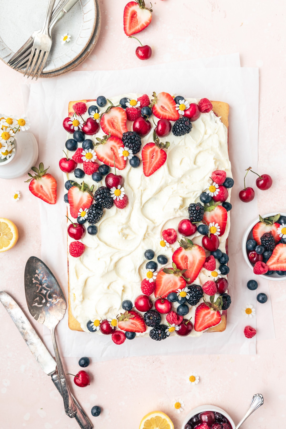 roasted berry sheet cake topped with fresh berries.