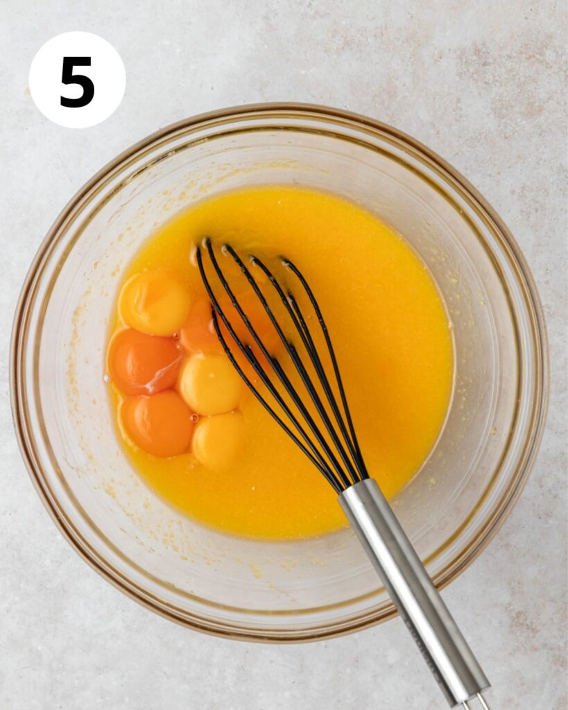 whisking egg yolks into mango curd.