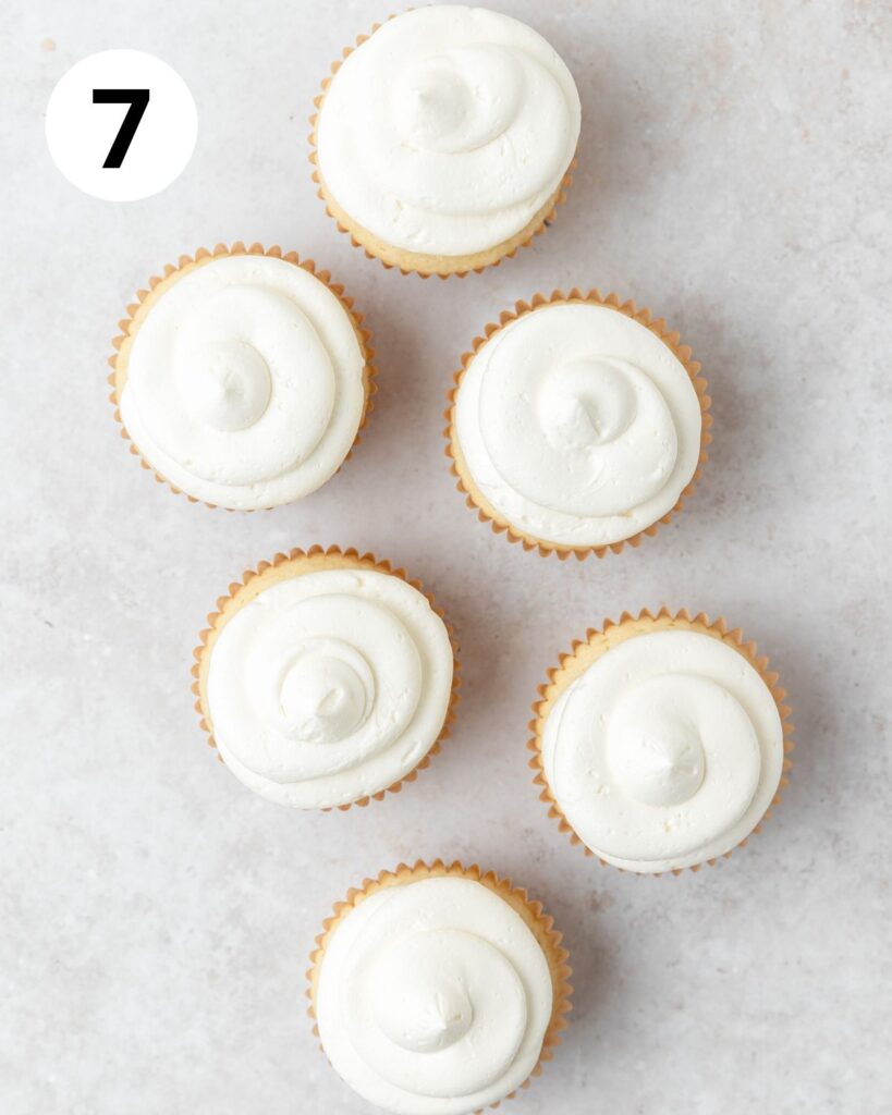 mango cupcakes topped with buttercream.