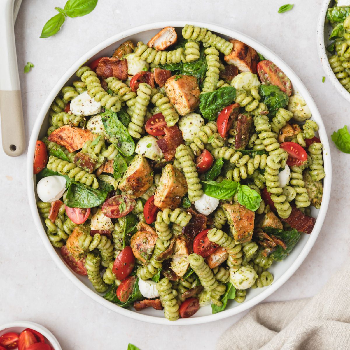 close up shot of chicken pesto pasta salad.