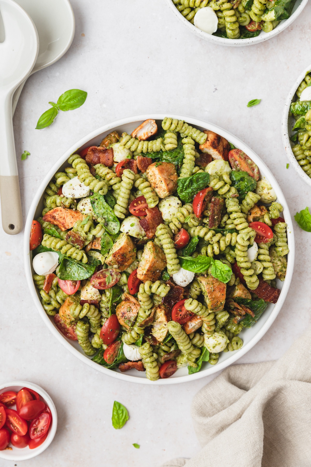 chicken pesto pasta salad with bacon and tomatoes.