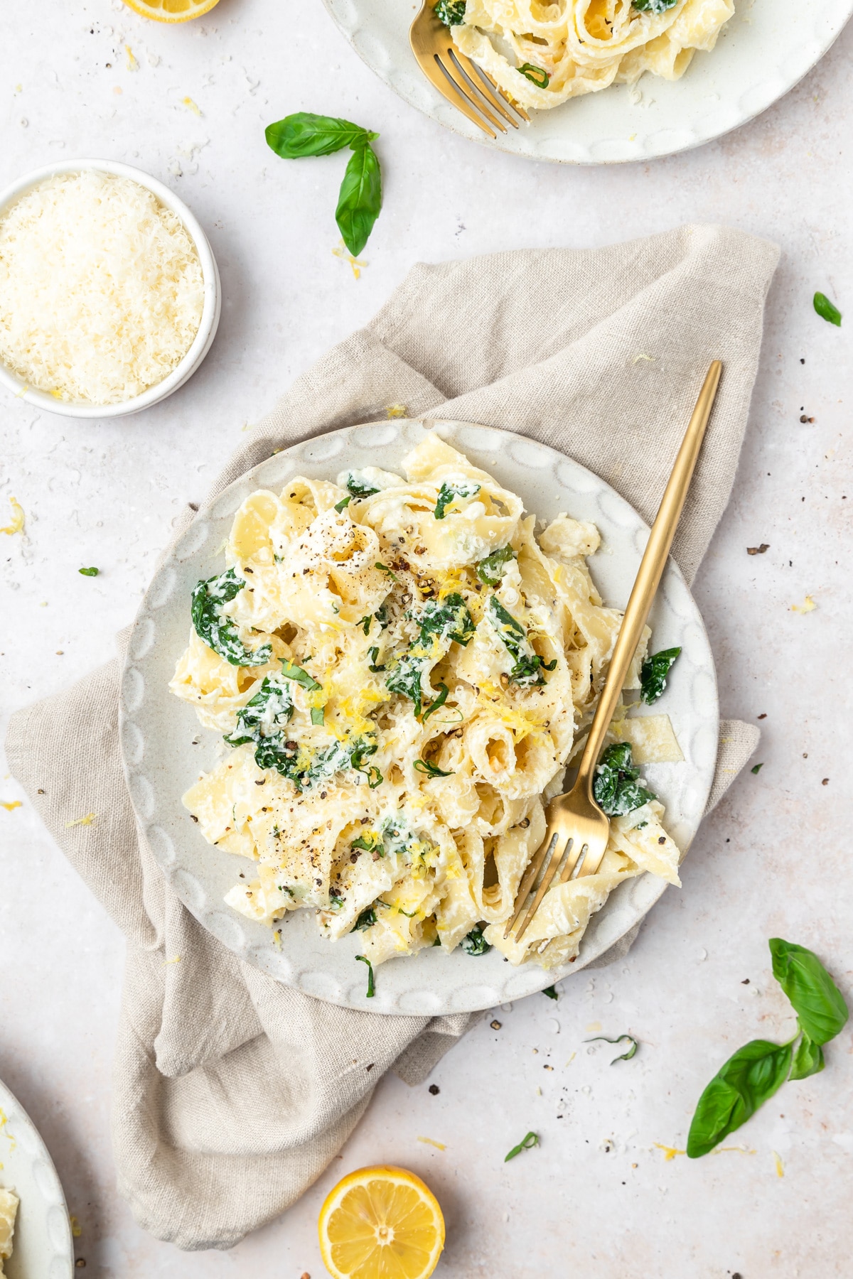 plate of lemon ricotta pasta with fresh spinach.