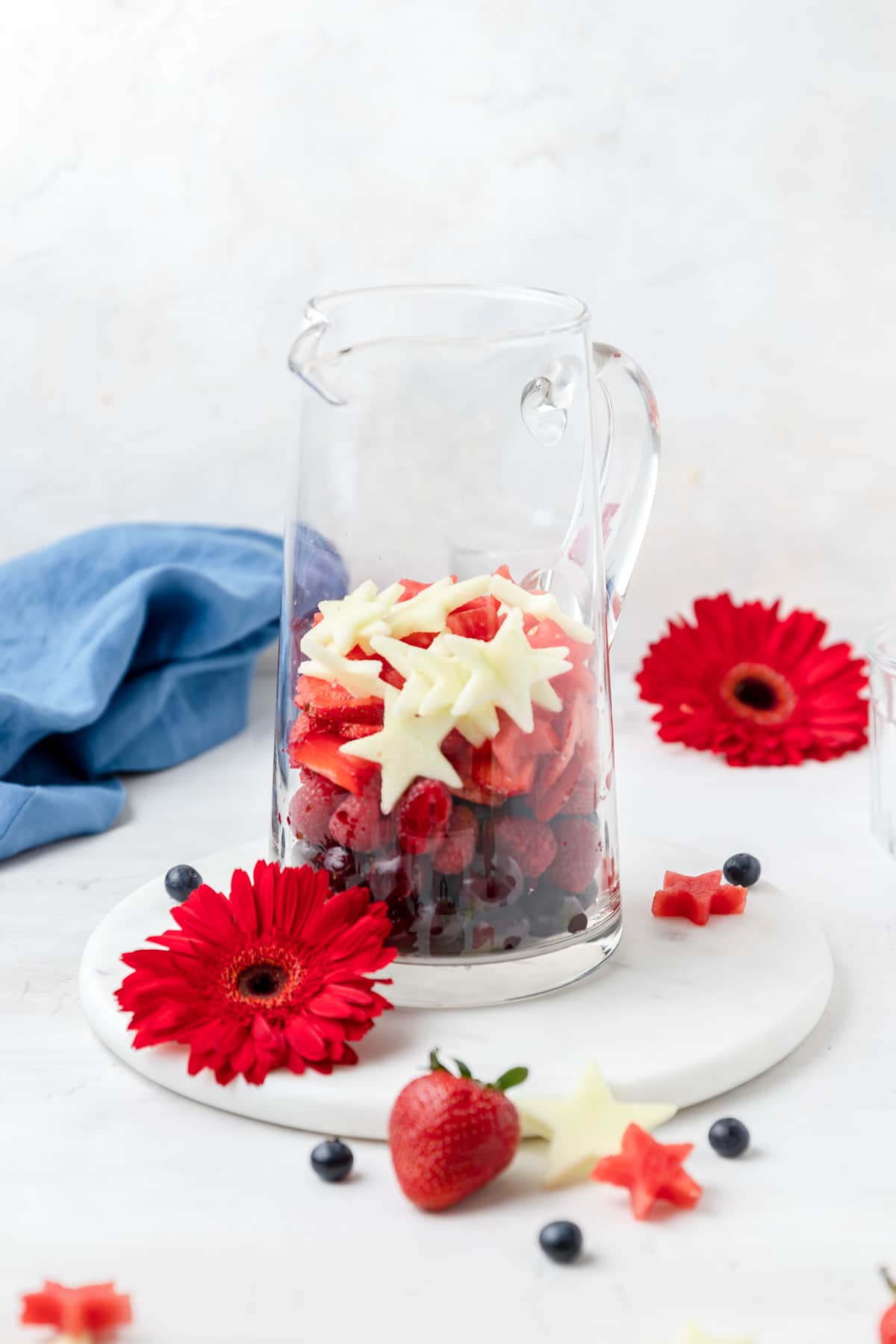 red white and blue fruit in pitcher.