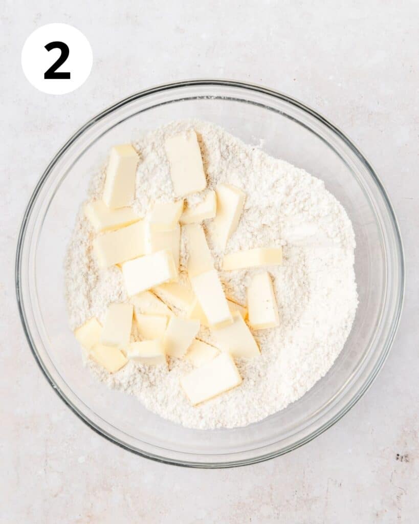 adding butter to pie crust.