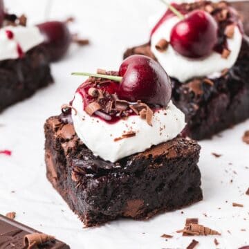 close up shot of black forest brownies topped with cherries.
