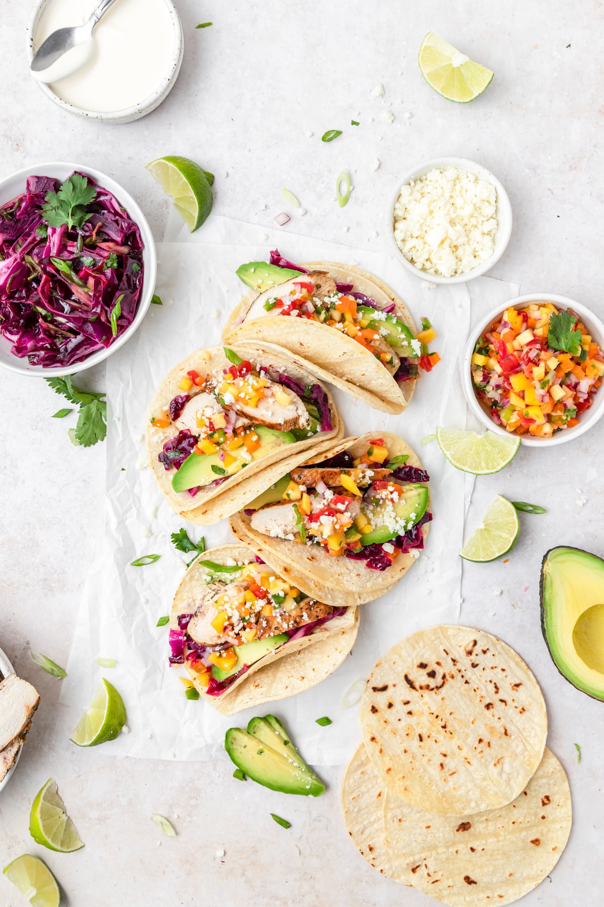 grilled chicken tacos on plate with cabbage slaw and mango salsa.